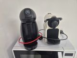 a coffee maker and a coffee cup on a microwave
