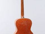 a wooden guitar hanging from a string on a white background