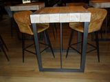 tables and chairs in a restaurant with wooden tops and metal legs