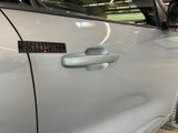 a close up of a car door handle with a sticker on it