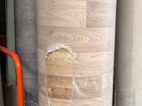 many rolls of paper sitting on a shelf in a warehouse