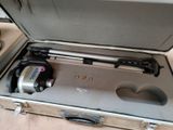a suitcase with a camera inside of it on the floor