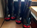 several bottles of wine are lined up on a shelf in a store