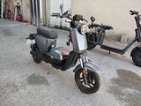 two scooters parked next to each other in a parking lot
