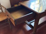 a wooden table with a drawer in the middle of it