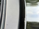 a close up of a car ' s rim with a small hole in it