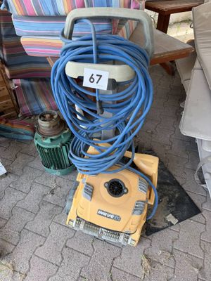 a yellow machine that is sitting on the ground next to a couch