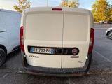 a white van parked in a parking lot next to a white van