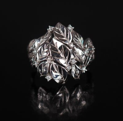 a close up of a silver ring on a black surface