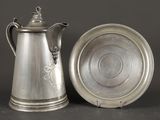 cafetière et soucoupe en métal argenté sur fond noir