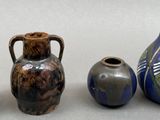 three vases are sitting next to each other on a table