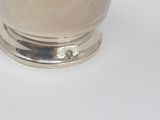 a silver cup that is sitting on a table