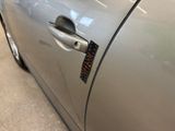 a close up of a car door handle with a sticker on it