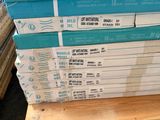 several stacks of books stacked on top of each other on a pallet