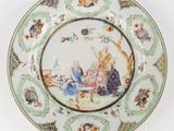 une assiette sur laquelle est représentée une femme et un chat