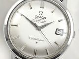 a silver watch with a white dial on it