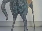 a statue of a dog with a collar on it ' s back