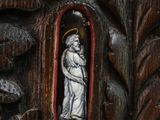 a wooden carving of a woman holding a child