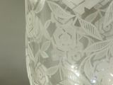 a glass vase with a pattern on it sitting on a table