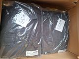 two bags of clothing in a box on the floor
