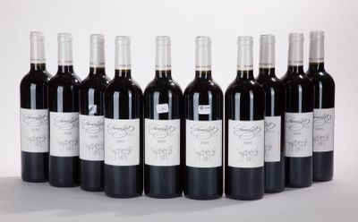 six bottles of wine are lined up in a row on a white surface