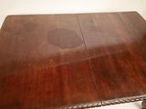 an image of a wooden table with two leaves on it