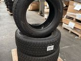 tires stacked on pallets in a warehouse with pallets in the background