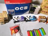 a box of cigarettes, cigarettes, and other items on a table