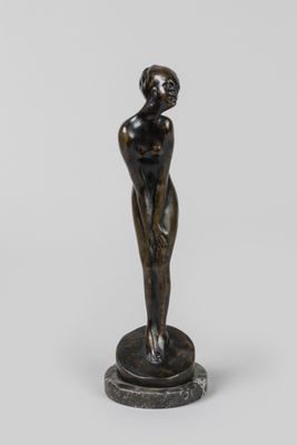 une statue de bronze représentant une femme debout sur un piédestal