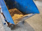 a blue wheelbarrow that is sitting in a room
