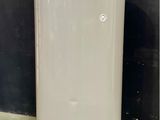 a white water heater sitting on a tiled floor