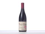 the bottle of red wine is sitting on the table