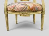 a gold chair with a colorful upholstered seat