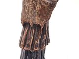bronze statue of a man with a hat and robe on top of a box