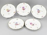 six porcelain plates with floral designs on them sitting on a table