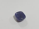 a close up of a blue stone on a white surface