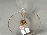 a wine glass that has a sticker on the inside of it
