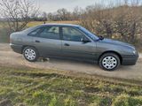 a car that is parked on the side of a dirt road