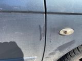 a close up of a car ' s door handle with a hole in it