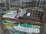 a metal cart that has a bunch of items inside of it