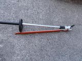 two tools that are laying on the ground next to each other