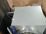 a cardboard box with a microwave inside of it
