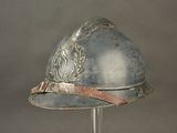 a silver helmet with a red band on top of it