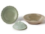two bowls and a plate on a white surface