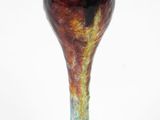 a vase that is sitting on a white surface
