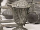 a table with a lot of silver items on it