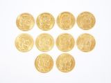 gold coins arranged in the shape of a heart on a white surface