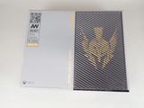 the box is open on a white surface with a black and gold design