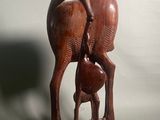sculpture représentant une biche et son faon, posée sur un socle en bois