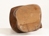 a wooden object that is sitting on a white surface
